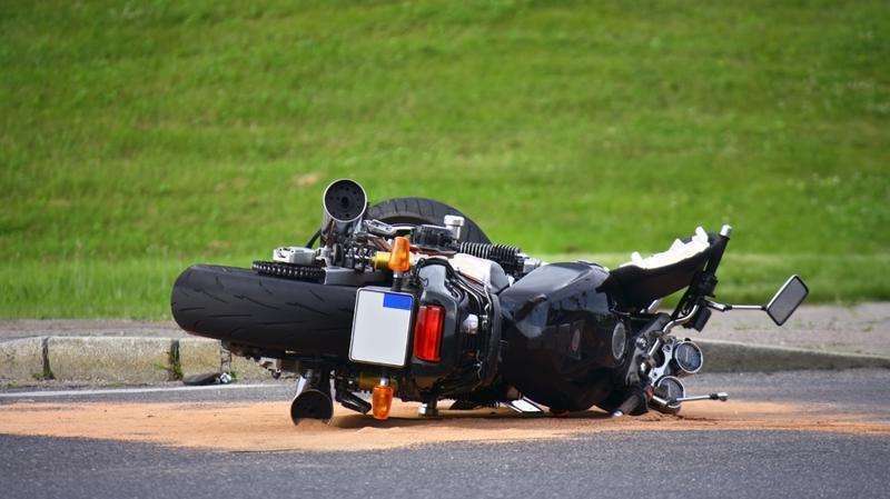 Motorcycle accidents or "motorcycle crashes" Motorcycle crash aftermath on Atlanta street, highlighting the urgent need for motorcycle accident claims to cover medical bills.