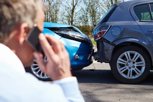 Driver making phone call after car accident in Sandy Springs, GA