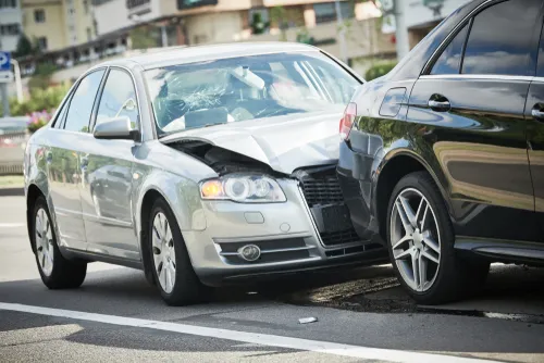 Cars are damaged on the street after a car accident in Snellville, GA