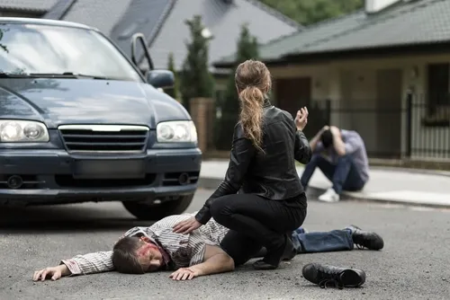 Bloody victim of car accident lying on the street in Rex, GA