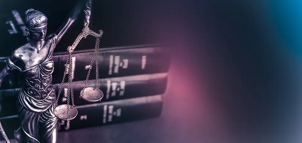 Law books and statuette of Lady Liberty
