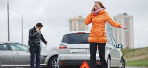 A woman on the phone after an Uber accident