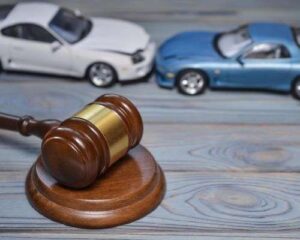Roswell accident attorney concept photo. toy cars and gavel