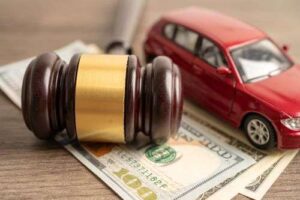 Snellville accident attorney costs concept, toy car with gavel and money