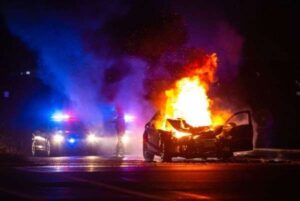 a car on fire, burn injuries in a car accident concept image