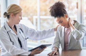 Car Accident Doctor Talking to Woman With Neck Pain