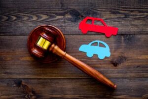 Deadline to file car accident lawsuit concept, paper cars with judge gavel