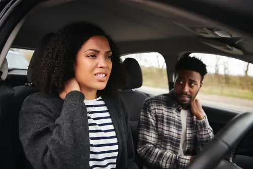 Car Accident Passenger Claim Concept, Couple With Whiplash from Crash