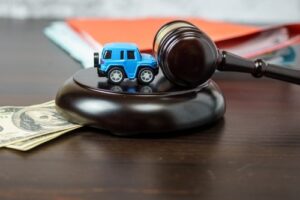 Atlanta Car Accident Lawyer Cost Concept, Toy Car on Judge Gavel