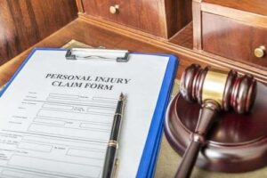 Personal injury lawsuit form and judge's gavel