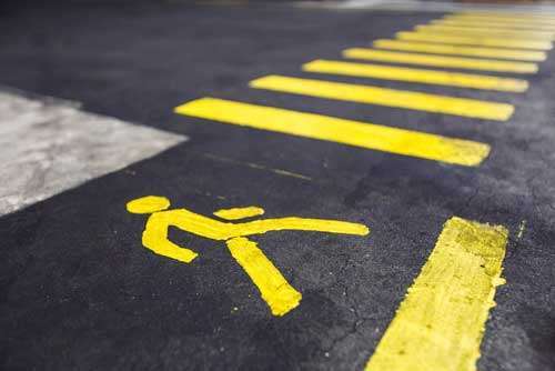Pedestrian crossing symbol painted on an asphalt road