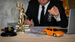 Car Accident Attorney with Toy Car, Car Keys, and Lady Justice