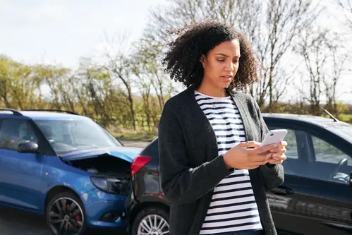 Woman On Phone After Car Accident