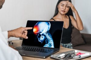 Doctor Looking at Woman's Brain Injury - Neurocognitive Injuries After a Crash