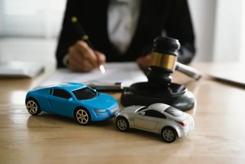 Athens car accident lawyer with judge gavel and model cars