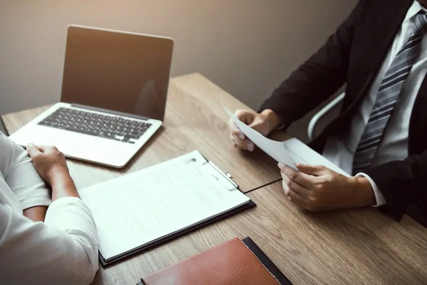 Georgia car accident lawyer reviewing an insurance settlement claim with an injured client