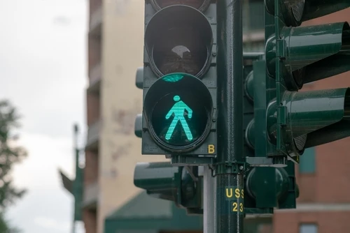 A traffic light pedestrian crossing symbol represents pedestrian right of way laws in Georgia.